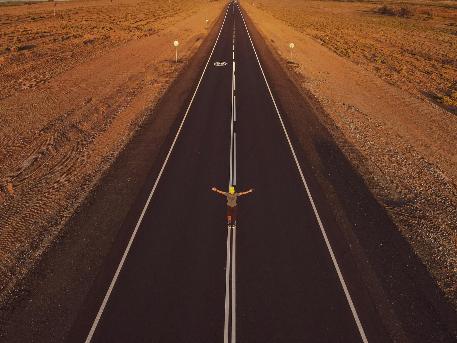 person reflecting on future self at a crossroads during sunrise