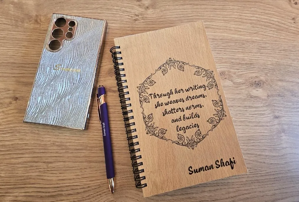 Personal branding essentials including a notebook, branded pen and workspace