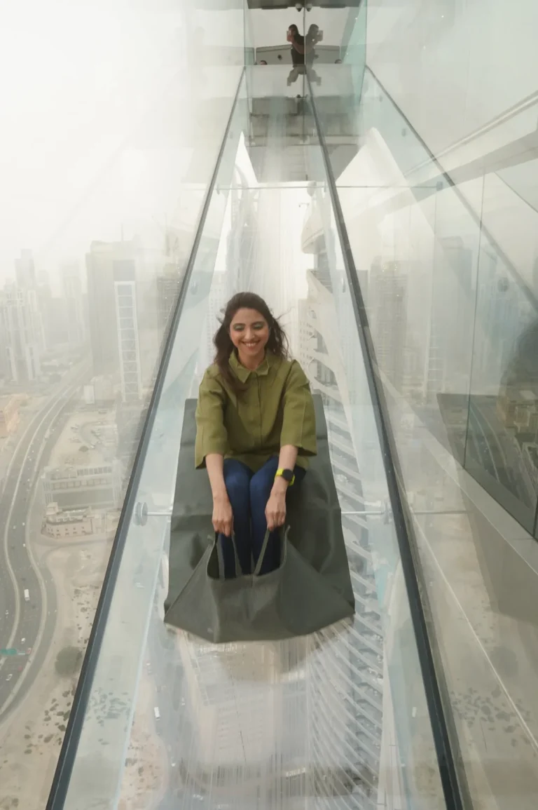 Suman Shafi experiencing the glass walk and glass slide above the Dubai skyline