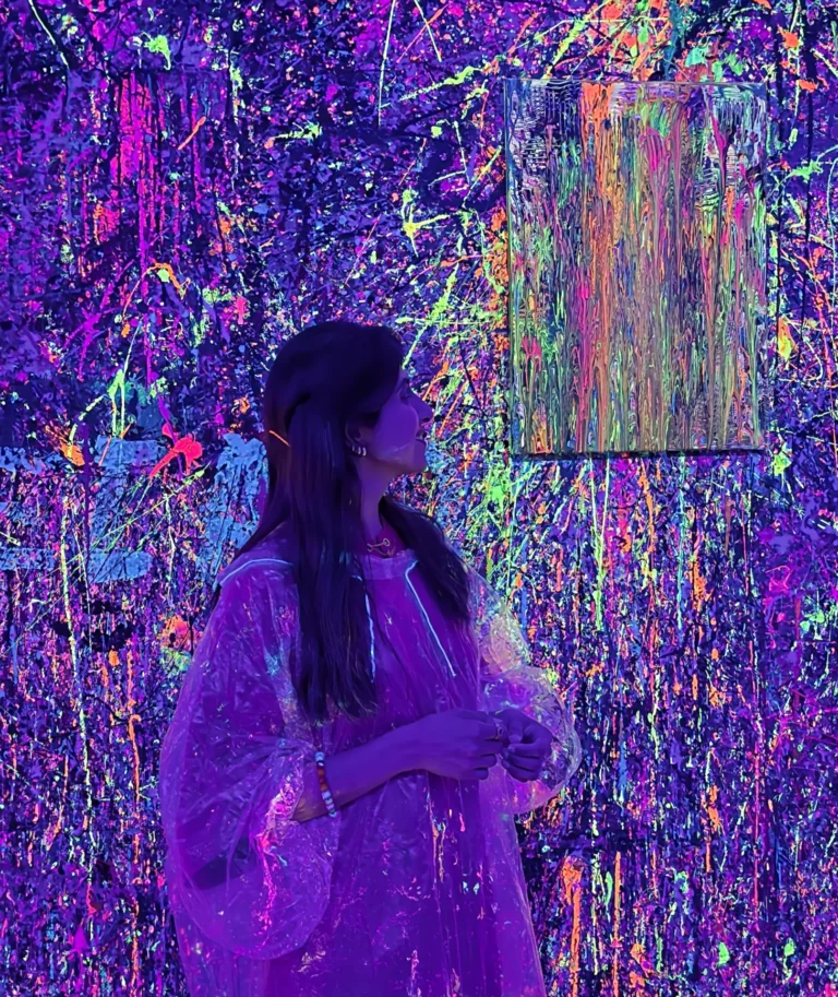 Suman Shafi creating colourful artwork during a neon painting workshop