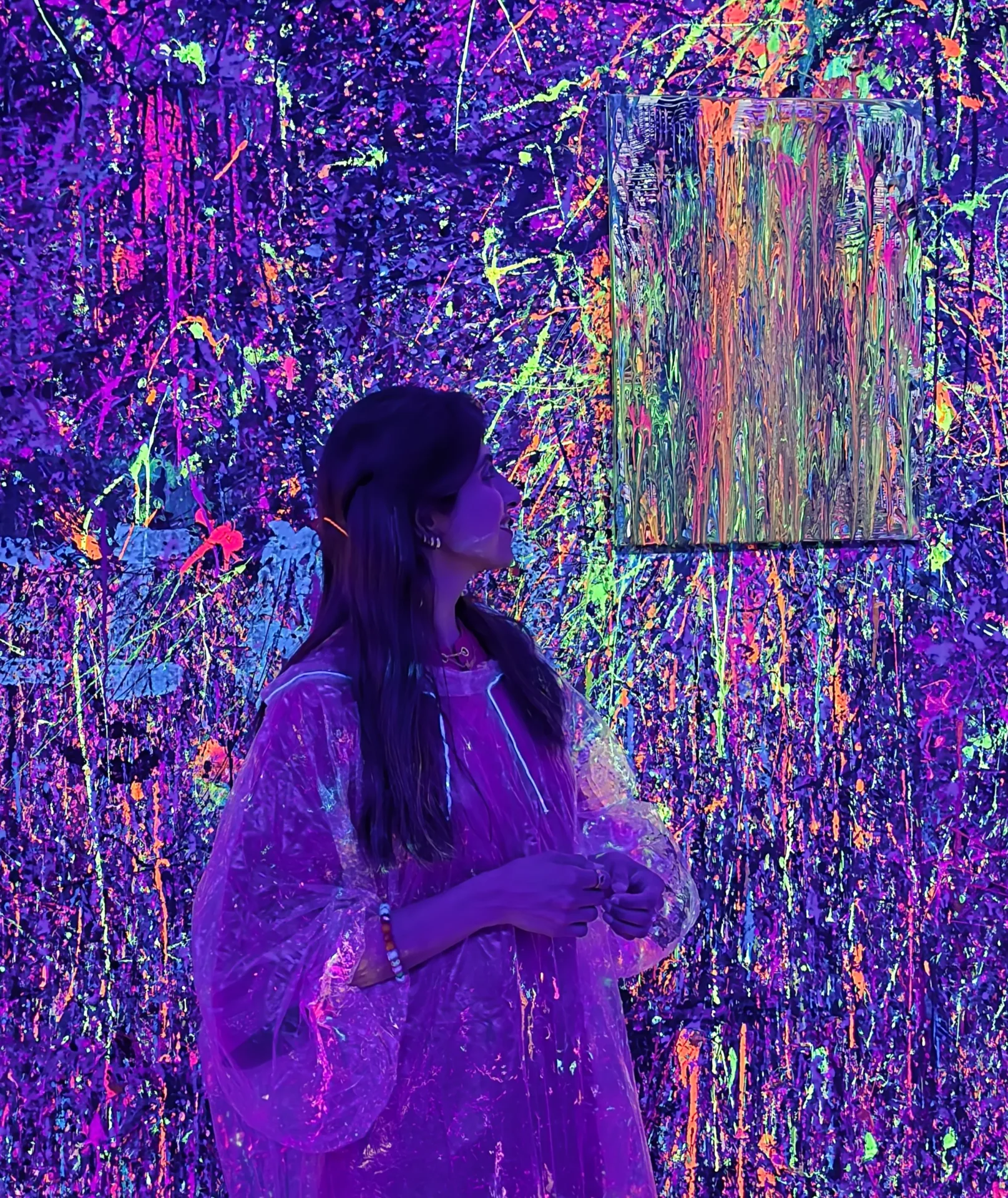 Suman Shafi creating colourful artwork during a neon painting workshop